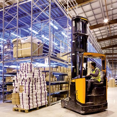 Warehouse Forklift truck between storage shelfs
